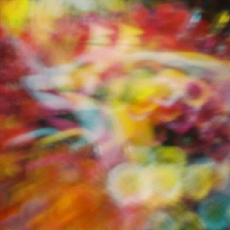 An abstract image featuring a blend of vibrant colors in a blurred composition.