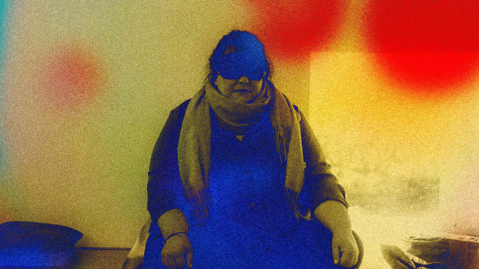A person sits in a meditative pose, wearing a blindfold, suggesting a focus on inner senses and a disconnect from external visual stimuli, relevant to the article's theme of feeling renewed.