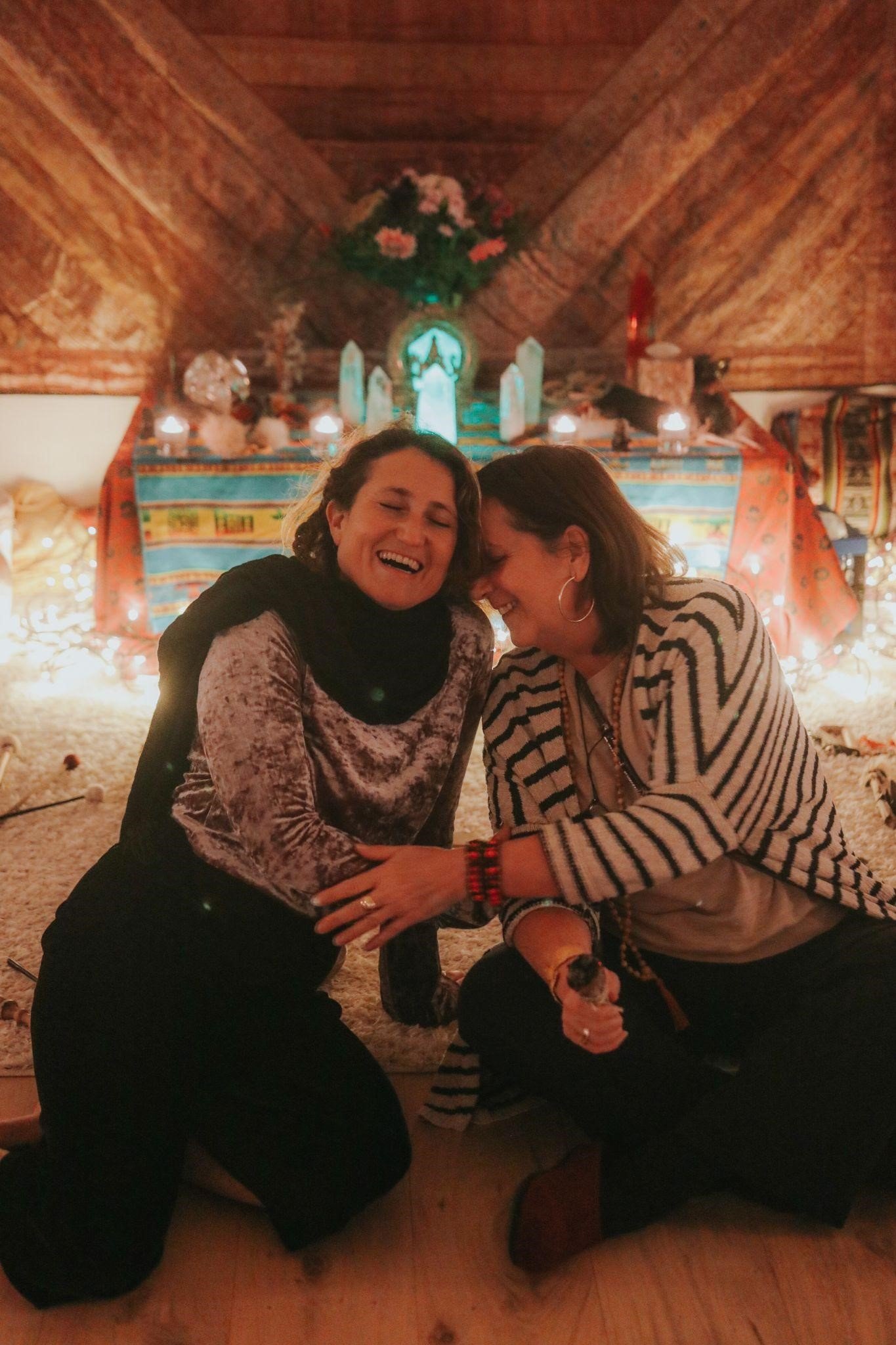 Two women embracing and laughing during a truffle retreat, embodying joy and connection.
